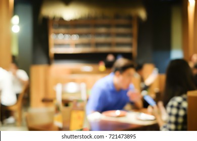 Abstract Blurred Group Of Asian Family Meeting Dinner In The Restaurant Background.