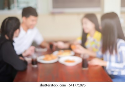 Abstract Blurred Group Of Asian Friends Meeting In The Restaurant Background:blurry Of Caucasian People Have Lunch Before Go To Working.