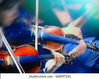 abstract blurred image. Actor violinist playing the violin strings. Musician plays a musical instrument on the concert stage                           