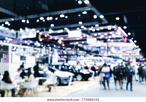 Abstract blurred image of cars exhibition show.
Blur background of international motorshow, Bangkok , Thailand. car
show room. Abstract blurred image of people in big events,
international cars
show.