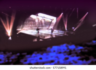 Abstract blurred image of a concert. Performances of artists in bright colorful scenes. spectators enjoyed a great show.