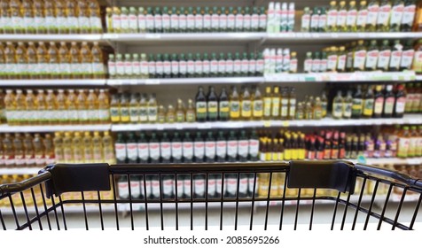 Abstract Blurred Image Of Cooking Vegetable Oil Bottles In Department Store. (Selective Focused At Shopping Cart)