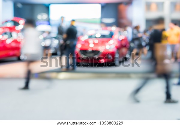 Abstract blurred image of crowd people in cars\
exhibition show 