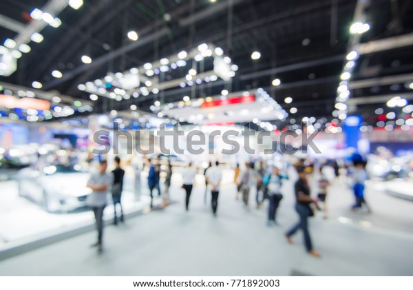 Abstract blurred image of crowd people in cars\
exhibition show  