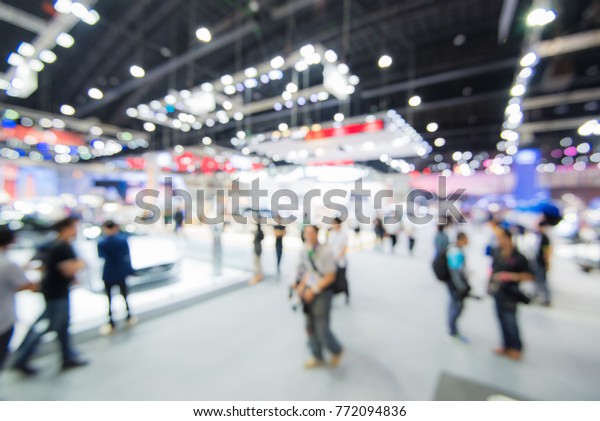 Abstract blurred image of crowd people in cars\
exhibition show  