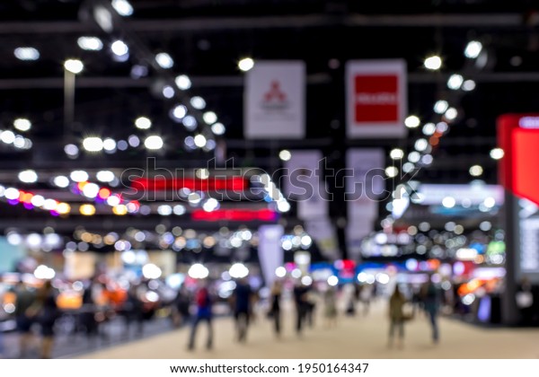 Abstract blurred image of exhibition show. Blur\
background of international motorshow, Bangkok , Thailand. car show\
room. Abstract blurred image of people in big events, international\
cars show.