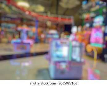 Abstract Blurred Image Of Game Zone Indoor. Bokeh Arcade Game Machine Inside Departement Store. 
