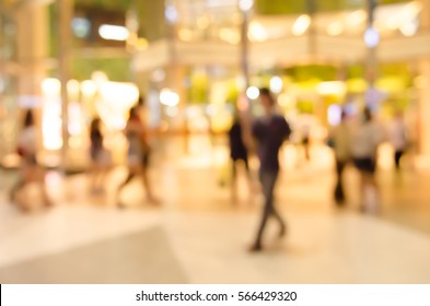 Abstract blurred image of many people walking at shopping center or department store at night use for background.