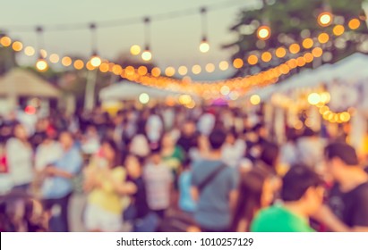 Abstract Blurred image of Night Festival on street  with light bokeh for background usage. (vintage tone)