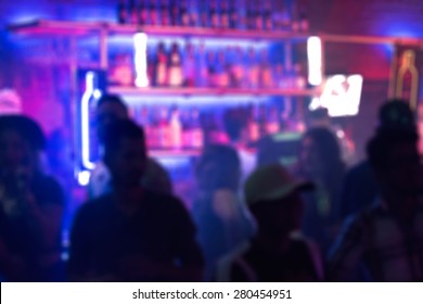 Abstract Blurred Image Of People Crowding The Bar In A Nightclub