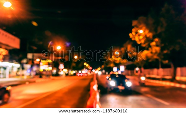 Abstract Blurred image\
of Road in night time  with light bokeh  for background usage.\
(vintage tone)