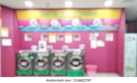 Abstract Blurred image of row of industrial laundry machines in laundromat in a public laundromat. 
