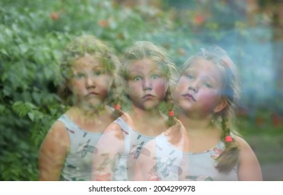 Abstract Blurred Image.Portrait Of A Girl - Three Emotions In One Frame. Multiple Exposure. Selective Focus. Different Personalities In A Person