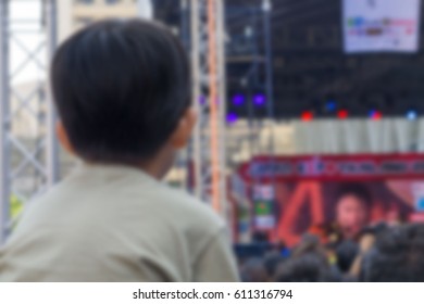 Abstract Blurred  . A Kid Sitting On The Shoulders Of His Father At Outdoor Concert 