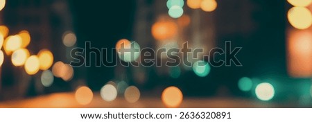 Abstract blurred lights bokeh effect in dark background for festive mood.