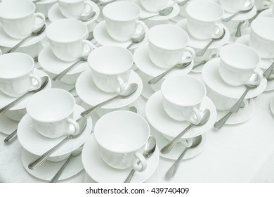 Abstract blurred of many white rows of coffee or tea cups for background.