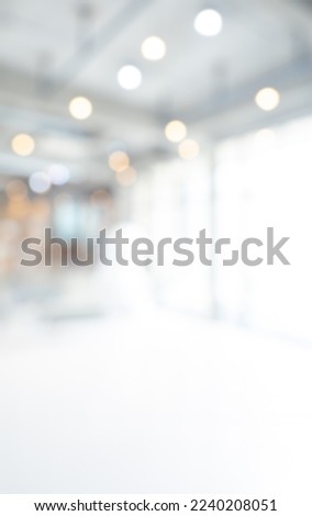 Abstract blurred modern workspace background, white indoor interior office or hospital with window and the light with copy space, vertical style. Blurry backgrounds for ad and business presentation.
