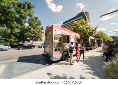 Abstract Blurred Motion Food Truck Vendor Customers Buy And Taste Variety Of Foods. People Waiting, Queuing In Line To Pick Up Lunch And Drink Delivery At Urban Park In Dallas, Texas, USA, Blue Sky