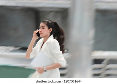 Abstract Blurred Motion Of Young Asian Business Woman Running To Work.