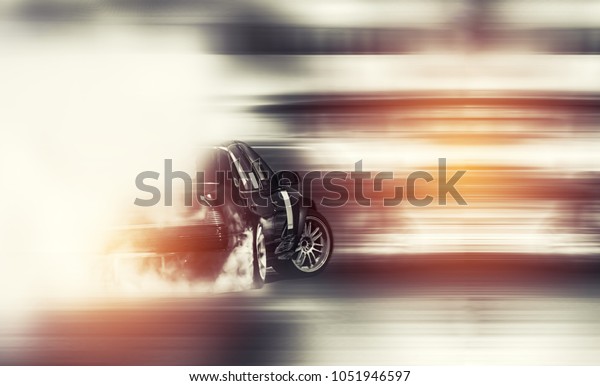 Abstract blurred\
old car drifting, Sport car wheel drifting and smoking on blurred\
background. Motorsport\
concept.
