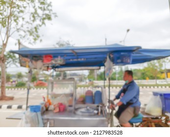 Abstract blurred photo of a Tricycle truck selling noodles running on the road. Thai people call "Saleng"