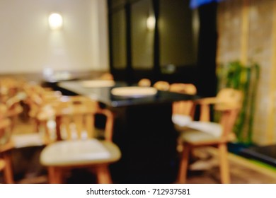 Abstract Blurred Shabu And BBQ Restaurant Interior With Empty Table Sets And Light Bokeh Background.