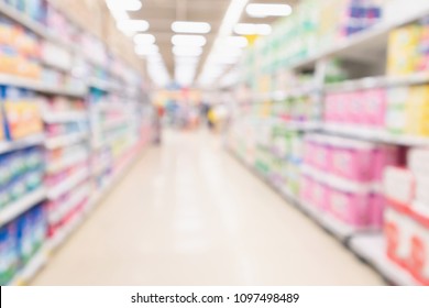 Abstract Blurred Supermarket Aisle And Shelves With Various Toilet Tissue Paper Display