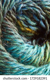 Abstract blurred swirl of coloured yarn to create a textured background.  Blues and greens.