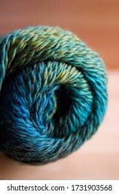 Abstract blurred swirl of coloured yarn to create a textured background.  Blues and greens.