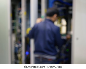 abstract blurred of technicians working in server room,data center. 