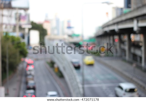 abstract blurred of traffic in the evening. It\
is going to rain  : blur of vehicles cars,saloon,bus,motorcycle,\
people at the road, Bangkok,\
Thailand.
