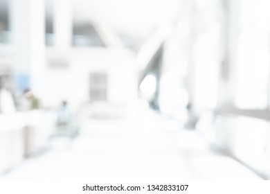 Abstract Blurred White Counter Medical Office Room Background Concept For Blur Empty Space Grey Hospital Clinic Pharmacy, Light Clean Interior Retail Sales Store, Blue Glare Window University Hallway.