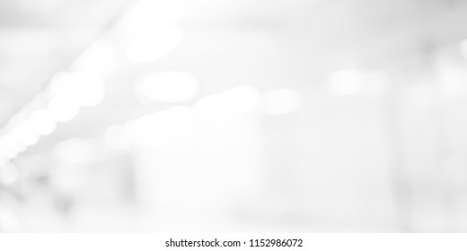 abstract blurred of white silver background of modern contemporary interior office with bokeh light for presentation design concept