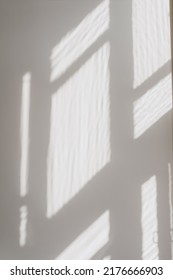 Abstract Blurred Window Sunlight Shadows On Neutral White Concrete Wall. Aesthetic Sun Light Shades. Out Of Focus