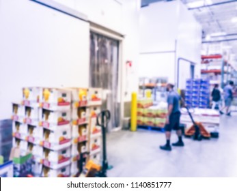 Abstract Blurred Worker With Manual Forklift Stockpile Goods Near Cold Storage Room In Wholesale Store