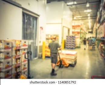 Abstract Blurred Worker With Manual Forklift Stockpile Goods Near Cold Storage Room In Wholesale Store