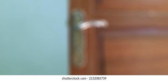 Abstract Blurring Brown Door And Gold Doorknob Background