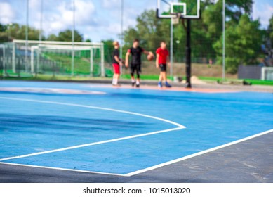 Abstract, Blurry Background Of Boys Playing Basketball In Outdoor Basketball Court In Park