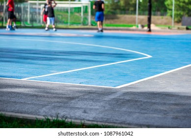 Abstract, Blurry Background Of Boys Playing Basketball In Outdoor Basketball Court In Park