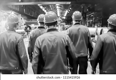 Abstract, blurry, bokeh background, image for the background. People in overalls in production. black & white - Shutterstock ID 1115415926