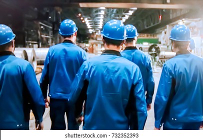 Abstract, blurry, bokeh background, image for the background. People in overalls in production - Shutterstock ID 732352393