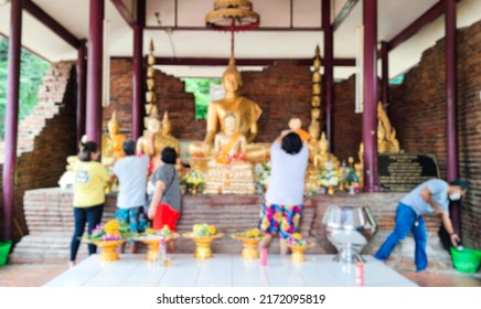 Abstract Blurry Crowd anonymous Buddhist people doing worship buddha statue in the temple. Buddhism ceremony of religion culture. Merit or worship. 