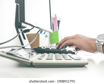 abstract blurry hand of man with keyboard and old srceen display with calculator. working office concept. work of busy and serious concept. salaryman concept. - Shutterstock ID 1908911791