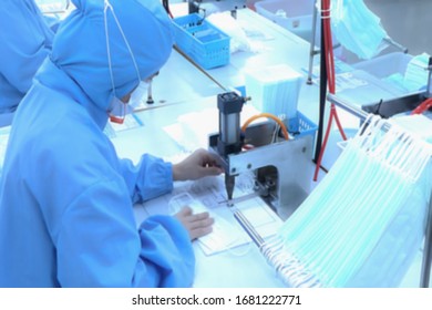 Abstract, blurry, out of focus image for media and internet. The concept of control and prevention with the coronavirus growing epidemic in the world. Production of antivirus masks. - Shutterstock ID 1681222771