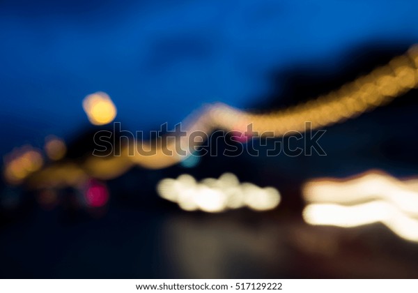Abstract blurry\
traffic road bokeh light view from inside a car. bokeh of\
decoration neon light on the road with dark and blur\
background.Abstract bokeh\
background
