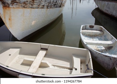 Abstract boat hulls in bay with  reflections