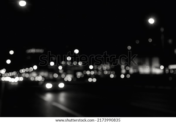 Abstract bokeh background of night street with car\
and street lamps. City life, defocused lights from cityscape, style\
color tone. Concept of abstract stylish urban backgrounds for\
design. Copy space
