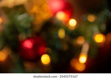 Abstract bokeh image featuring blurred Christmas lights and vibrant red and gold ornaments, creating a warm and festive atmosphere ideal for holiday-themed projects.