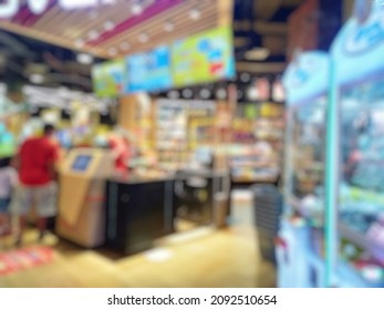 Abstract Bokeh Image Of Indoor Arcade Game Machine. Bokeh Image Of The Game Zone For Background Usage 

