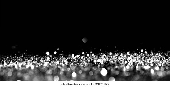 Abstract Bokeh Silver Light Glitter On Black Background.
Blurred Circle Black And White Sparkle Magic Background. 